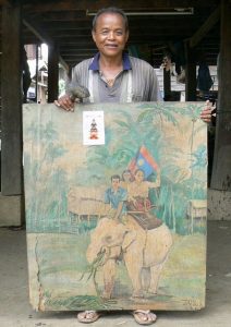 Boun Somsy, with a painting of his white elephant that was liberated by the wife of the country’s first president.